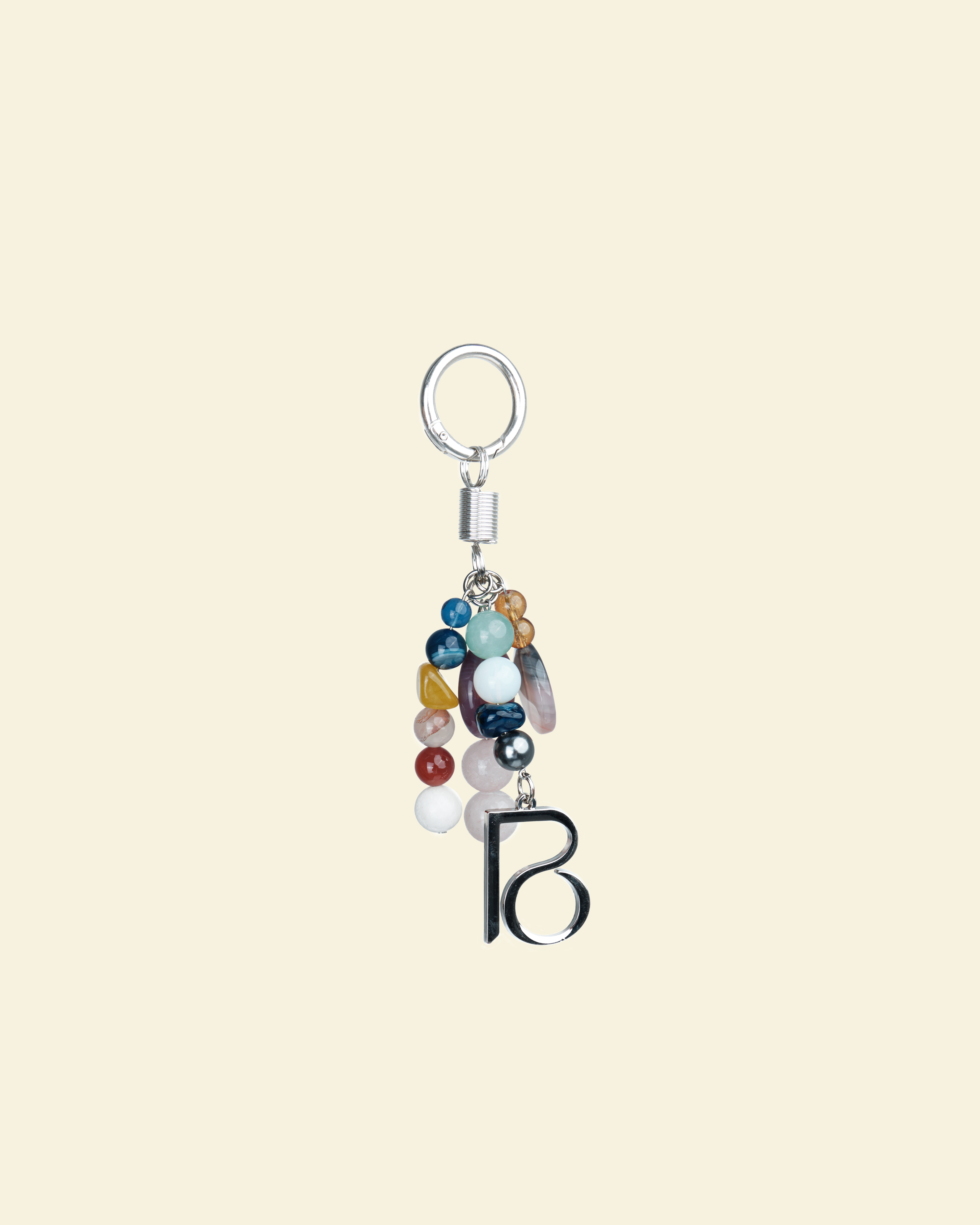 Keychain with colorful beads and a letter 'B' on a beige background